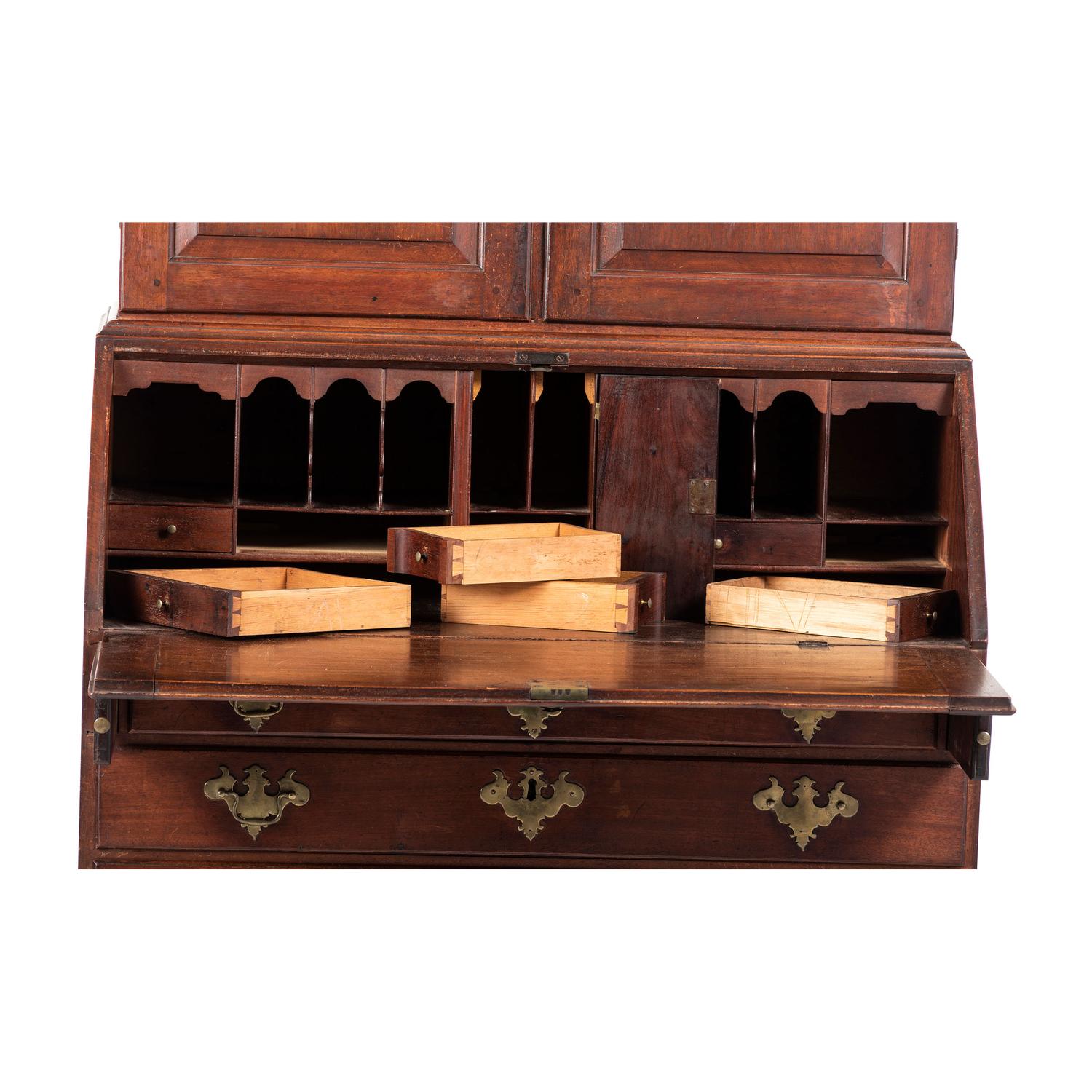 A Chippendale Carved and Paneled Mahogany Slant-Front Desk-and-Bookcase