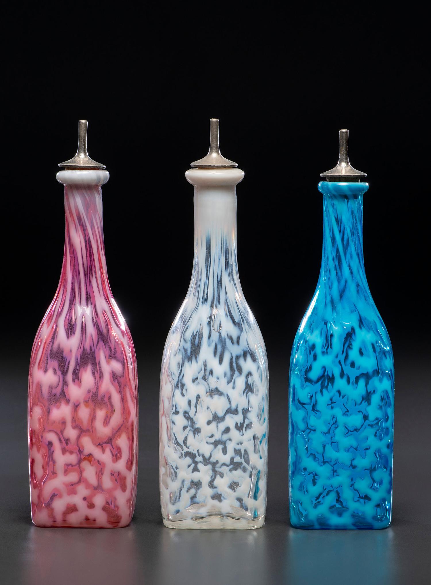 Three Coral Opalescent Glass Barber's Bottles