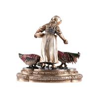 A Continental Ruby Mounted Silver and Enamel Figure, , in the form of a peasant woman feeding three birds.