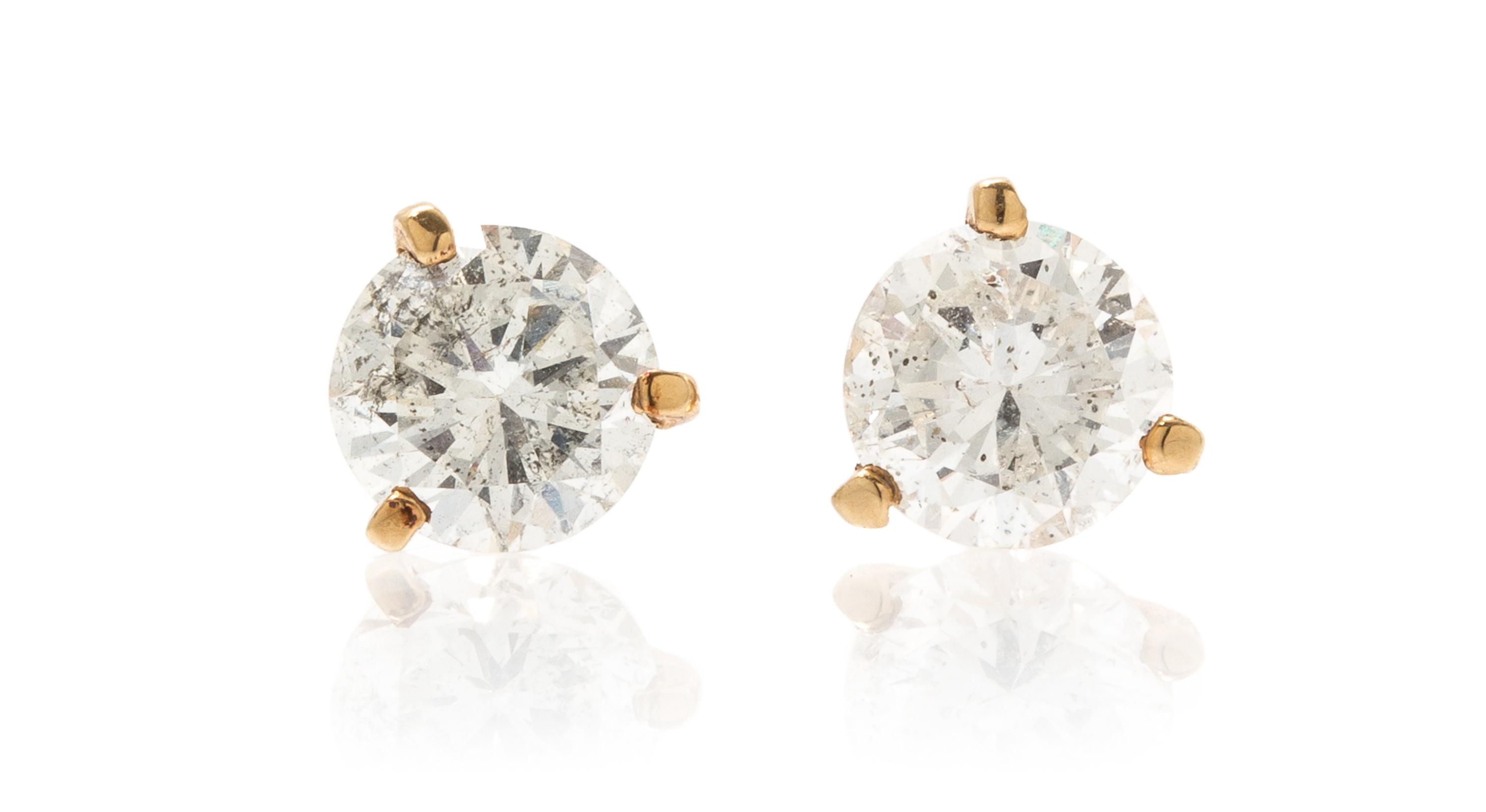 A Pair of 14 Karat Yellow Gold and Diamond Stud Earrings, 1.10 dwts.