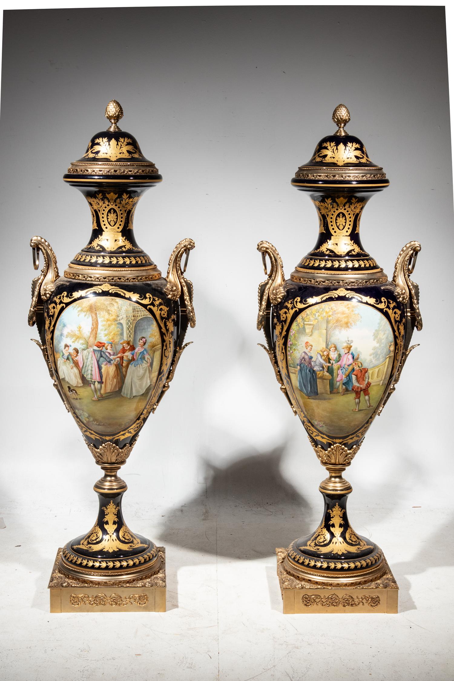 A Pair of Monumental Sèvres Style Gilt Metal Mounted Porcelain Covered Urns on Pedestals