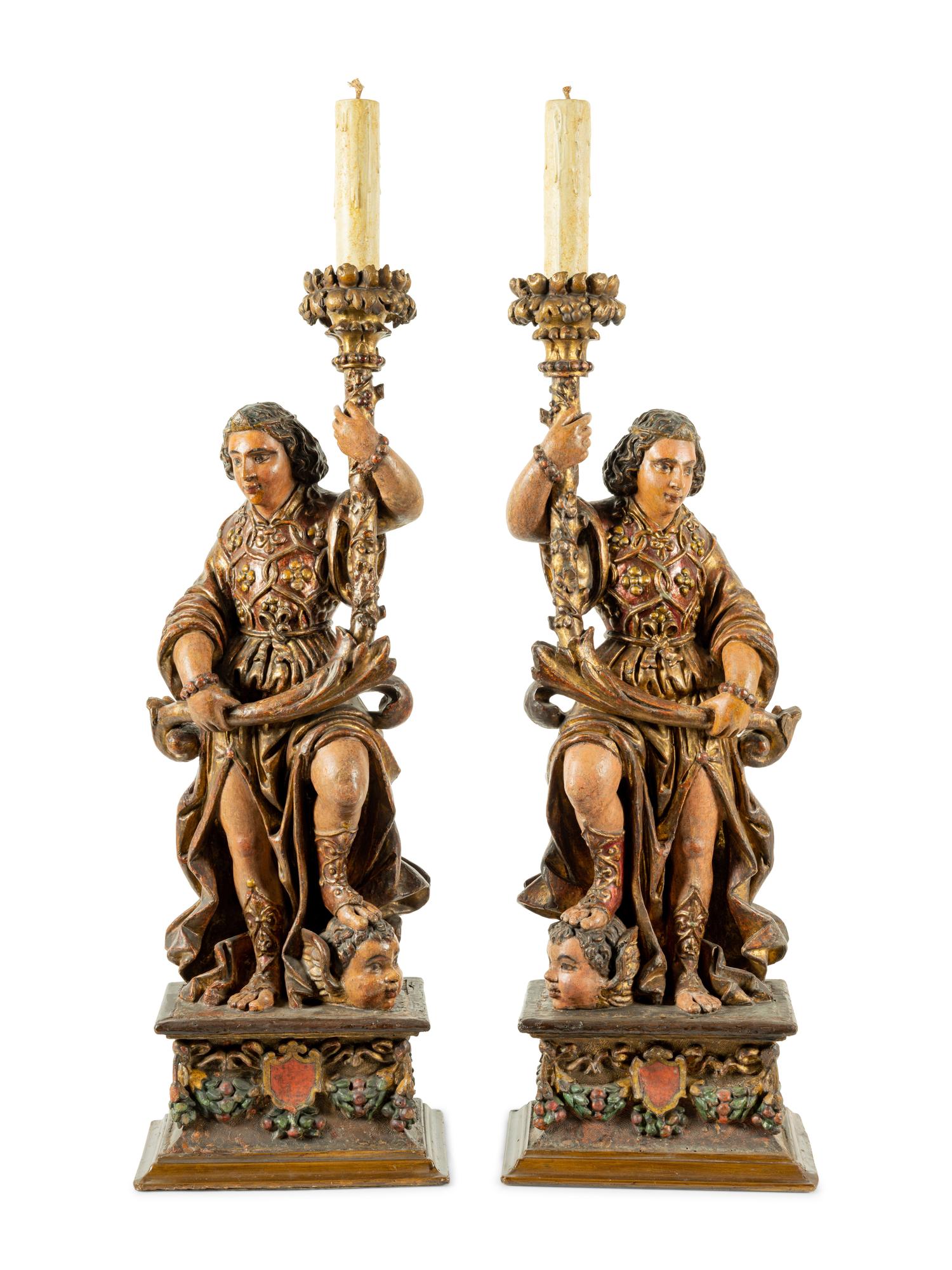 A Pair of Continental Carved, Painted and Parcel Gilt Figural Pricket Sticks