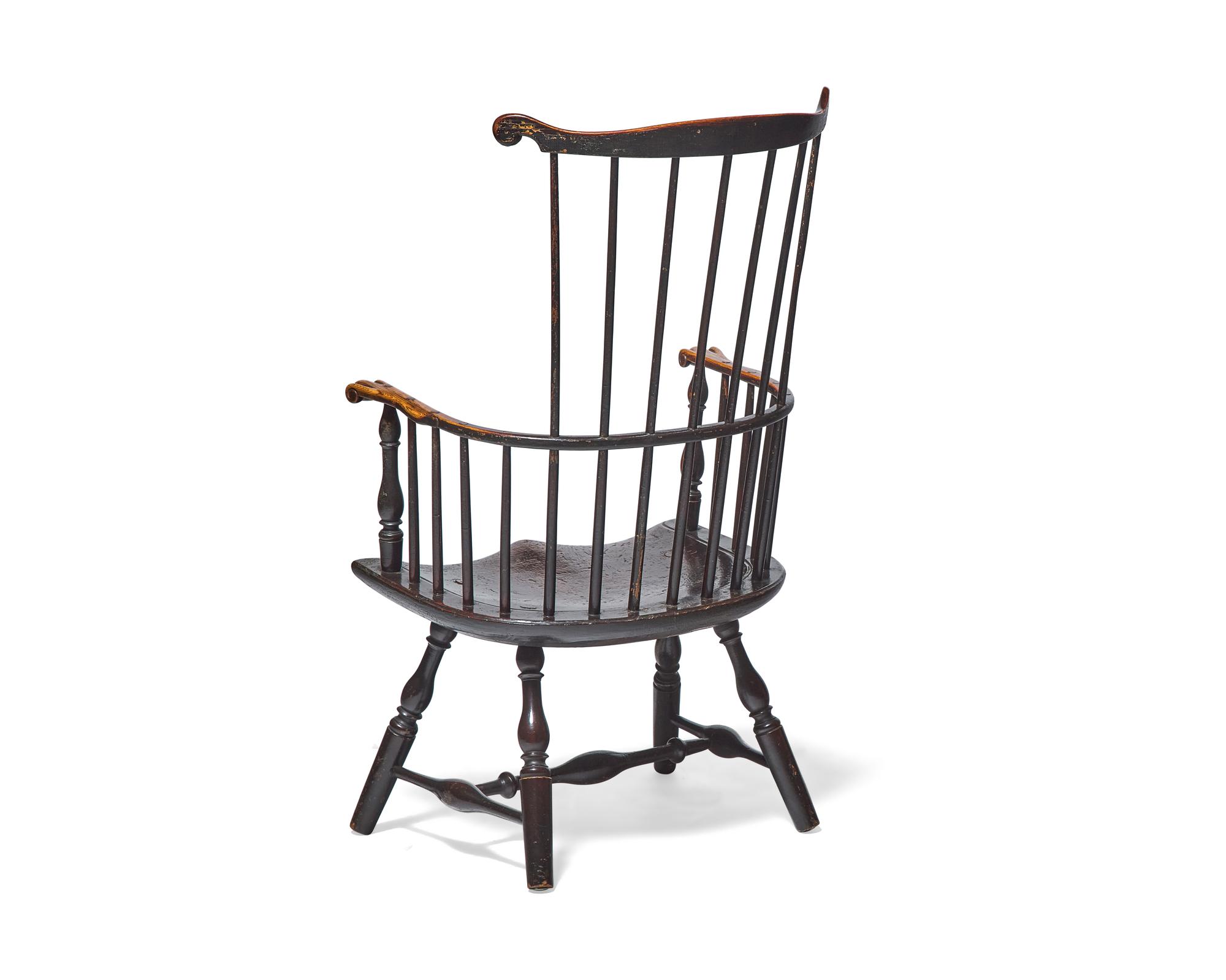 A Turned and Black-Painted Comb-Back Windsor Armchair