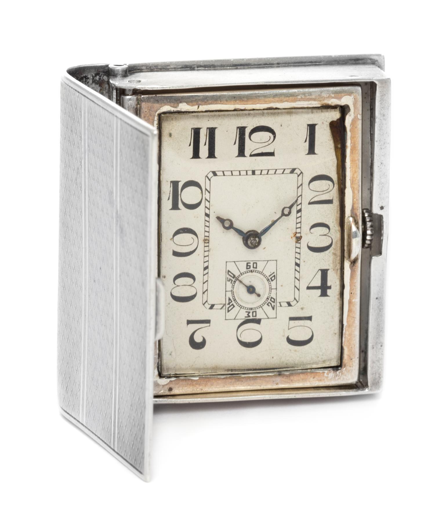 A French Silver Travel Clock, Georges Meyer, First Half 20th Century, in the form of a book, opening to a rectangular dial with Arabic