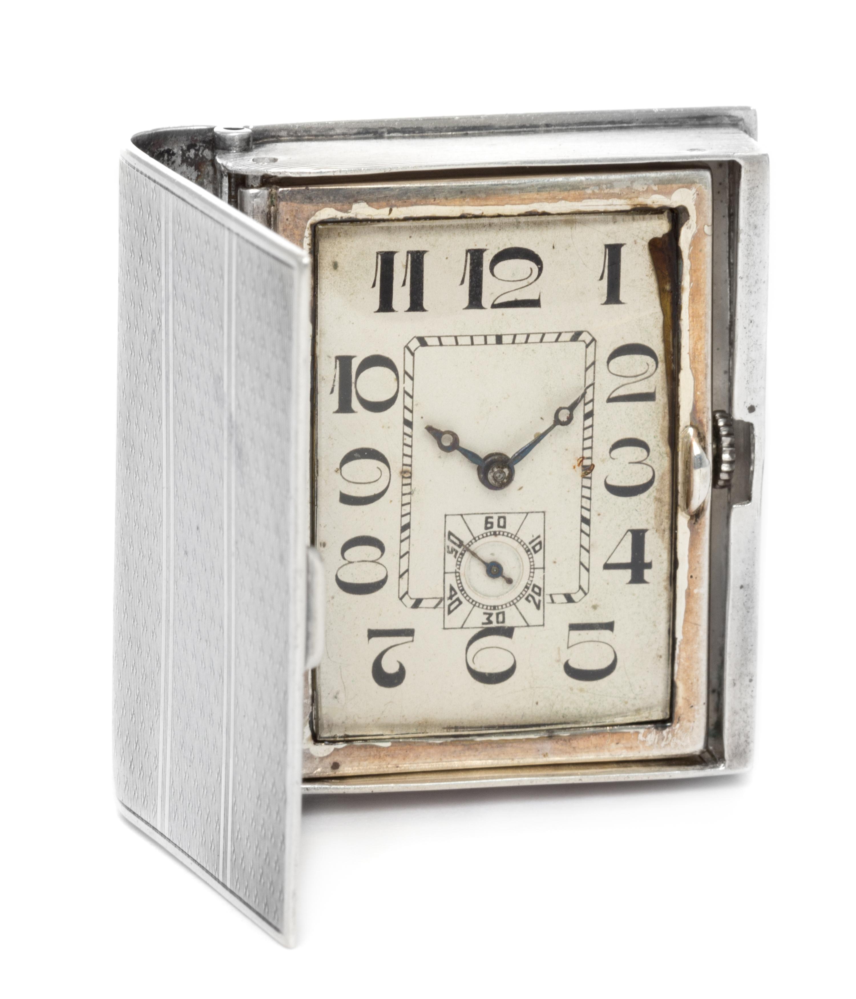 A French Silver Travel Clock, Georges Meyer, First Half 20th Century, in the form of a book, opening to a rectangular dial with Arabic
