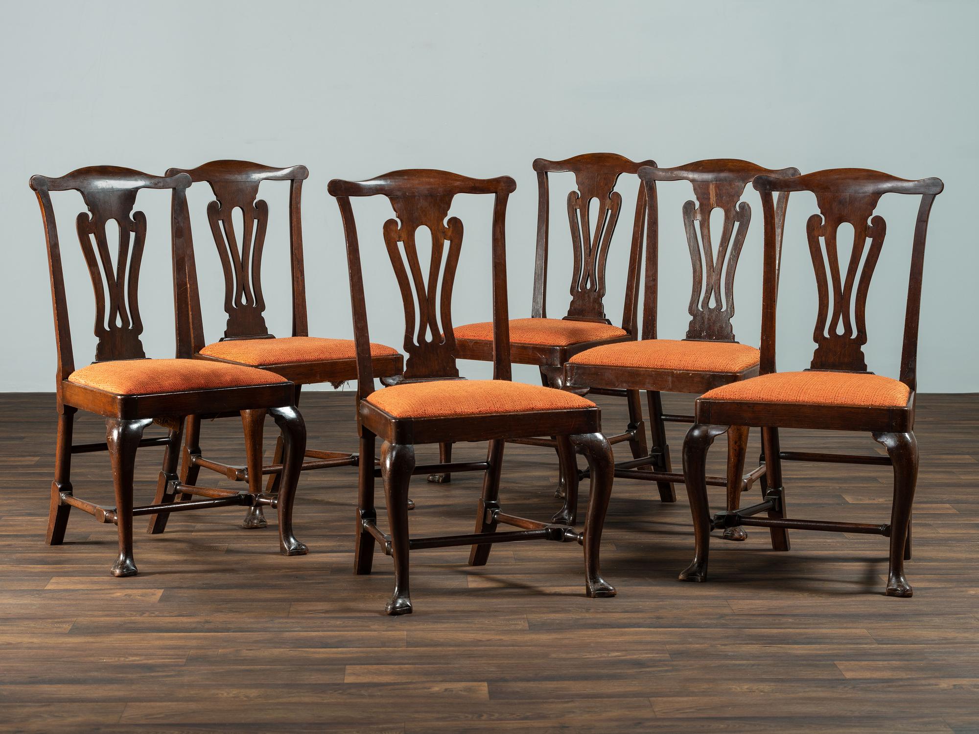 A Set of Six Queen Anne Pierce Carved Mahogany Stretcher Base and Trifid Foot Side Chairs