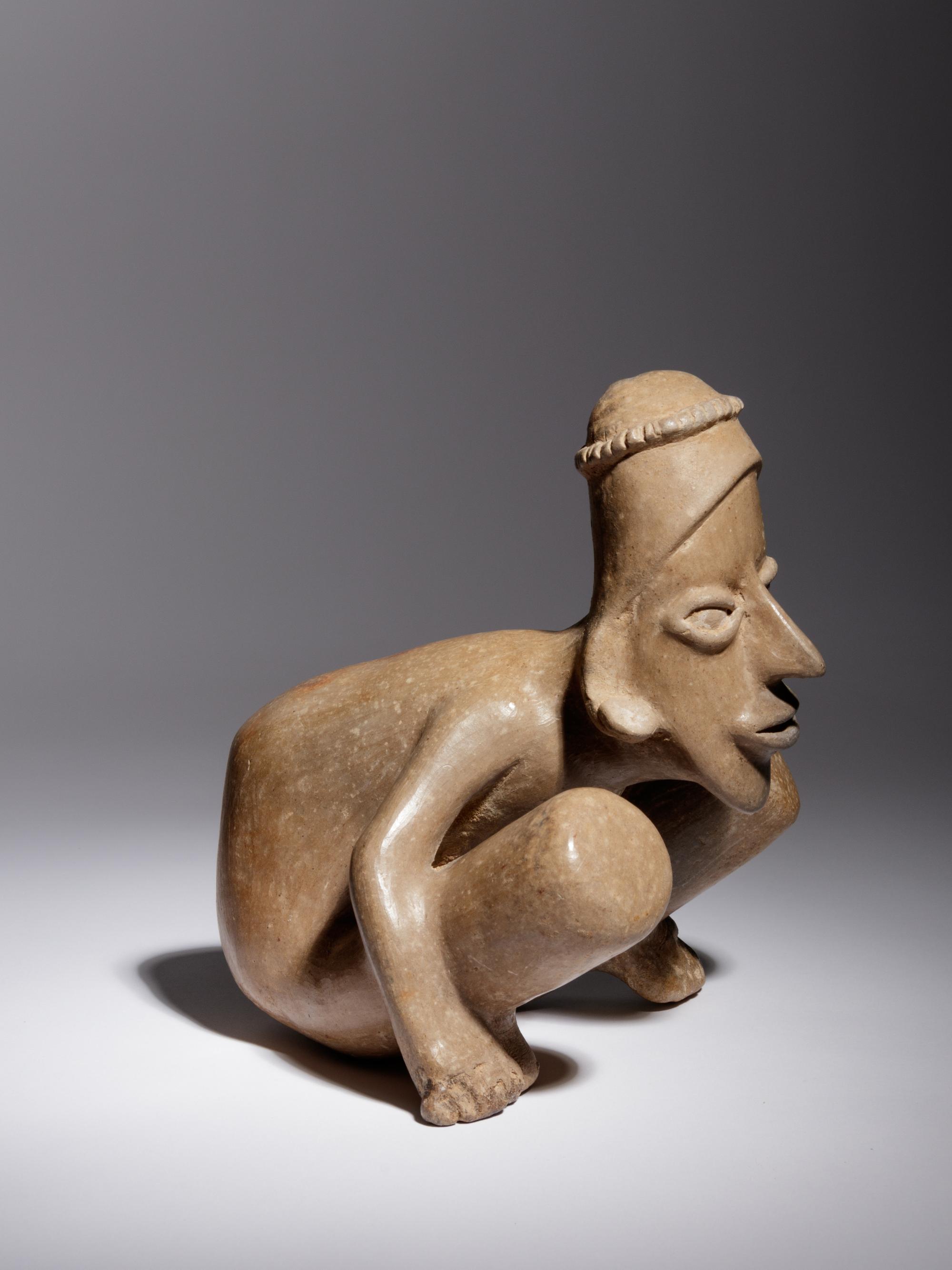 A Jalisco Pottery Crouching Figure