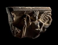 A Roman Marble Sarcophagus Fragment with Eros Holding Snakes