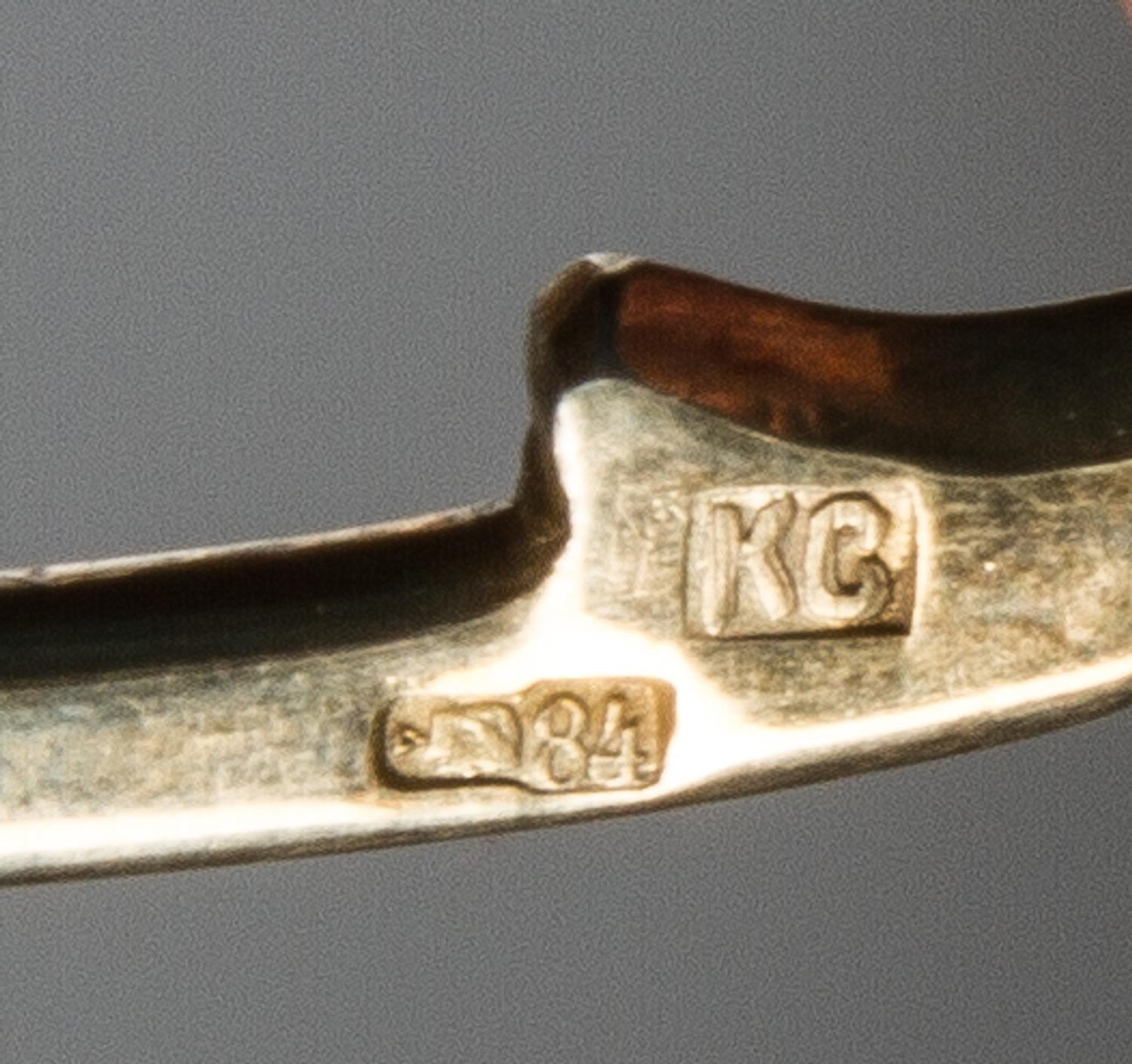 A Russian Silver-Gilt and Enamel Spoon, Mark of Konstantin Skortisov, Moscow, early 20th century, having a green and purple enameled fi