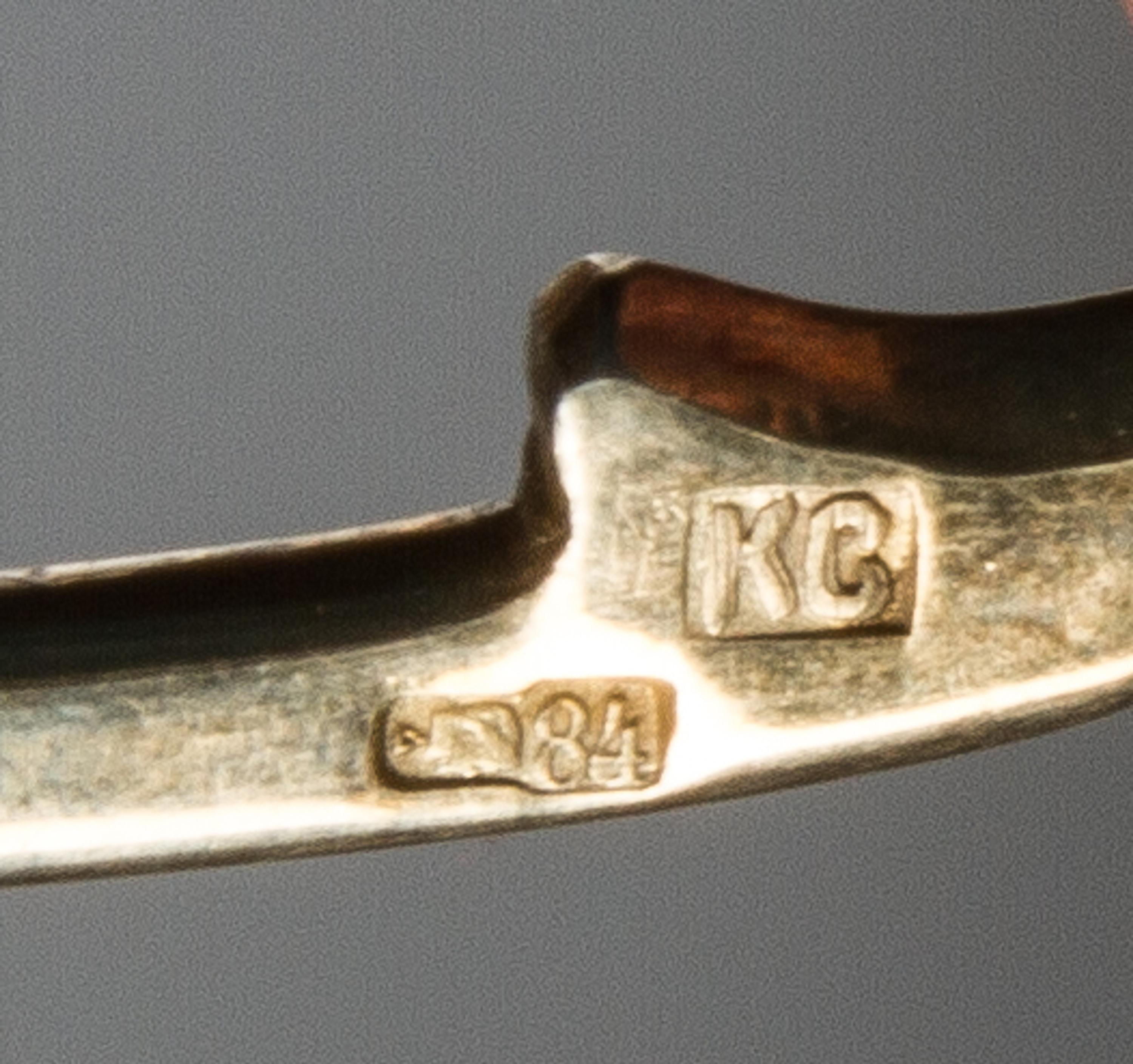 A Russian Silver-Gilt and Enamel Spoon, Mark of Konstantin Skortisov, Moscow, early 20th century, having a green and purple enameled fi