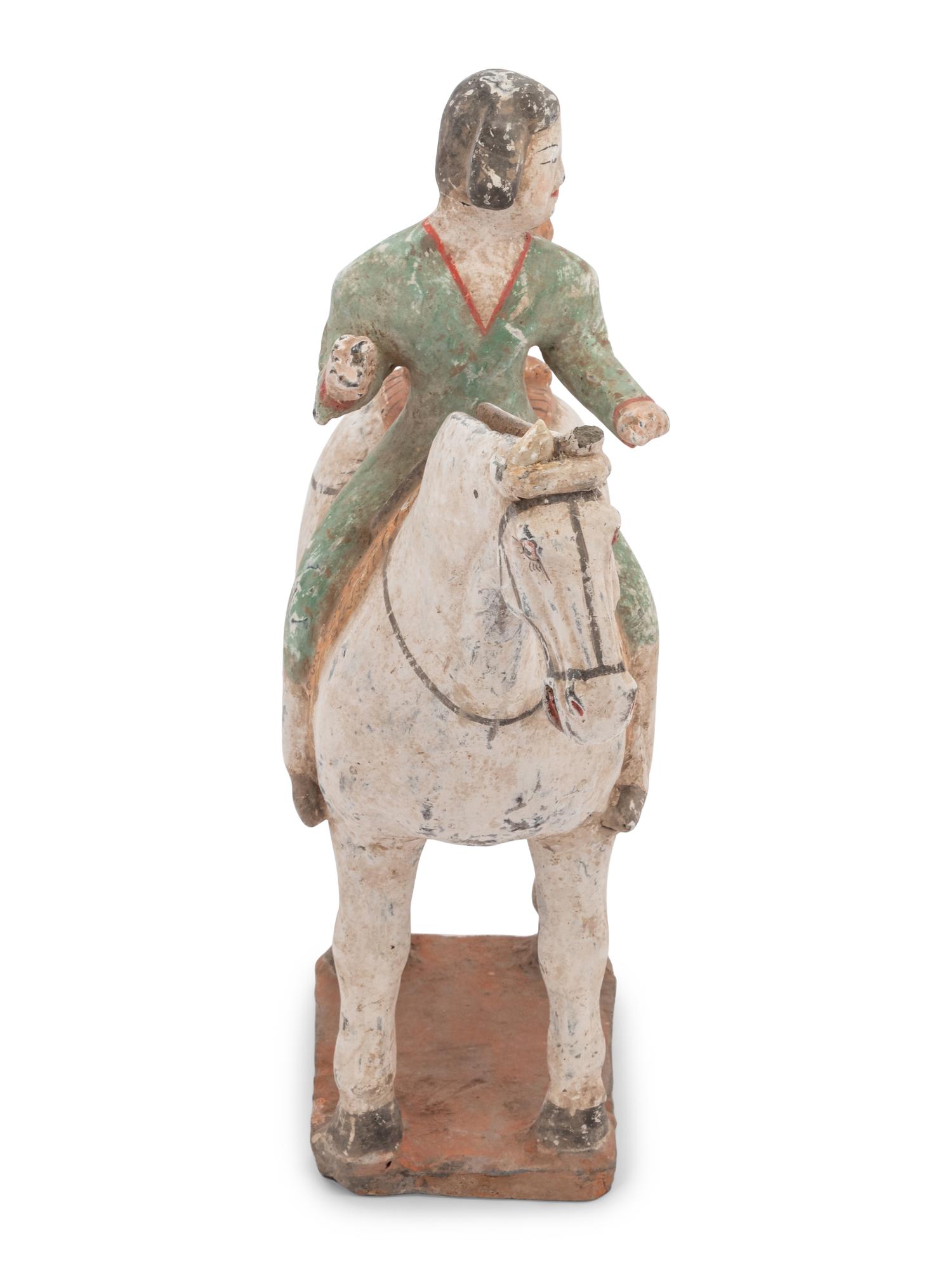 A Chinese Painted Pottery Figure of an Equestrienne with a Leopard