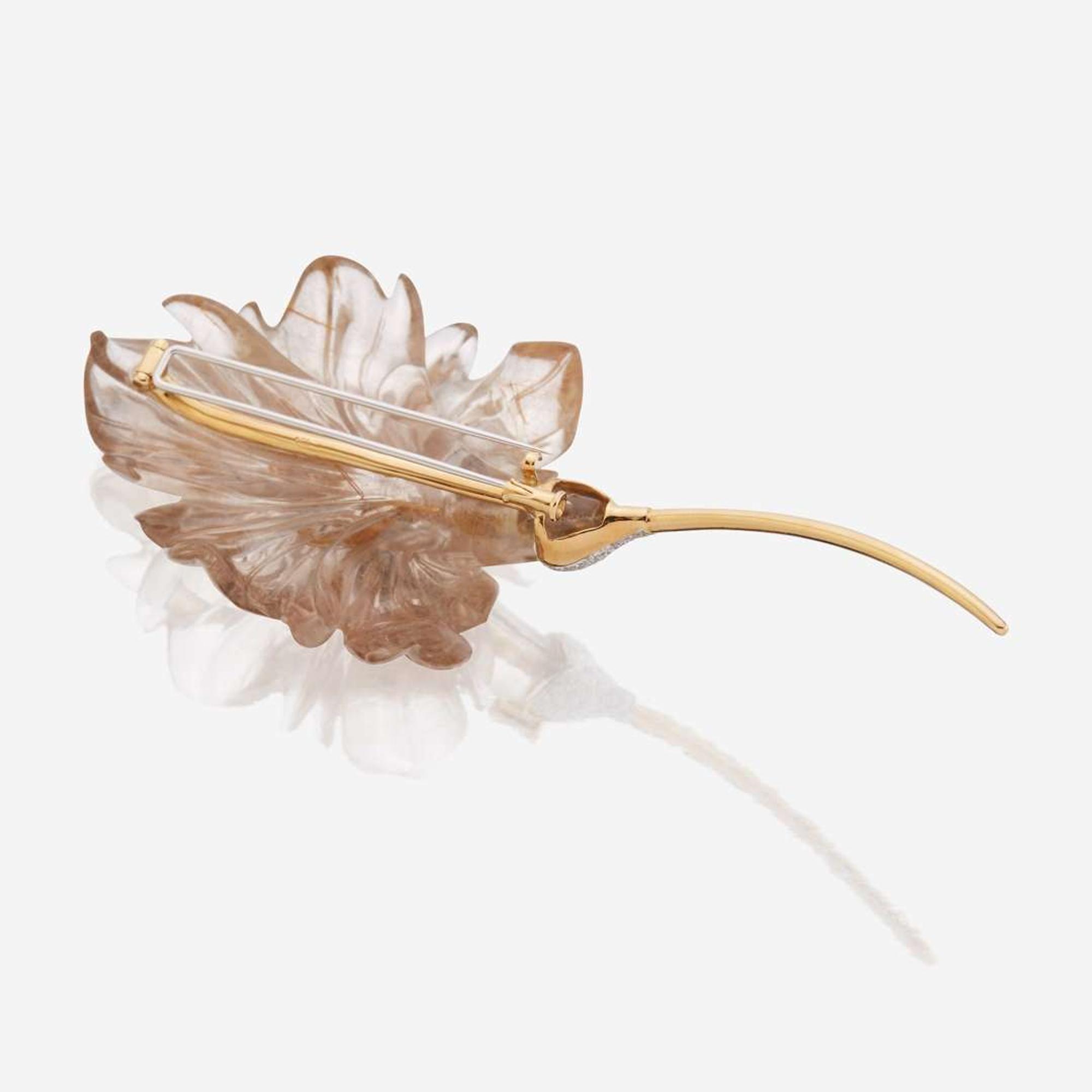 A rutilated quartz, diamond, and eighteen karat gold brooch