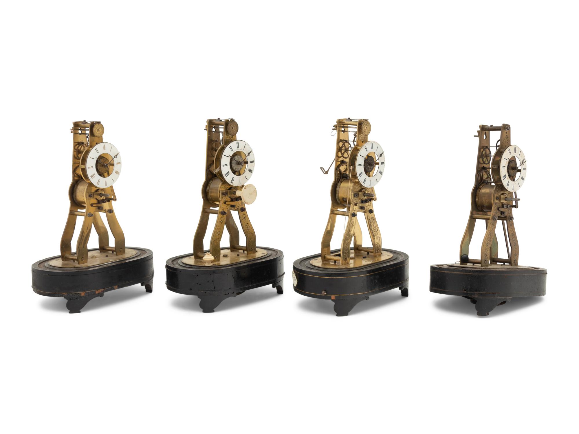 A Group of Four Brass Skeleton Clocks