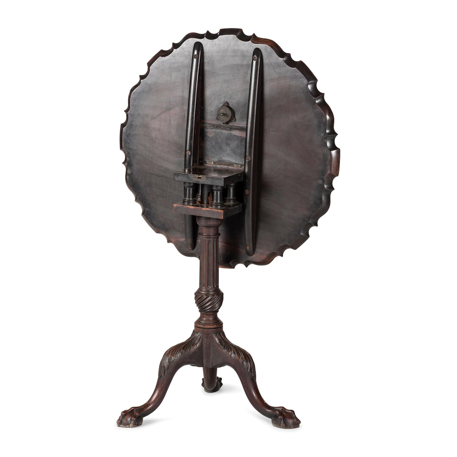 A Chippendale Carved and Figured Mahogany Pie-Crust Tilt-Top Tea Table