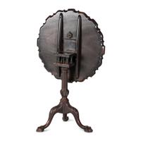 A Chippendale Carved and Figured Mahogany Pie-Crust Tilt-Top Tea Table