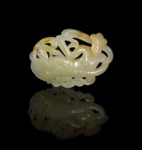A Carved Jade Toggle of an Apsara Width 2 inches.