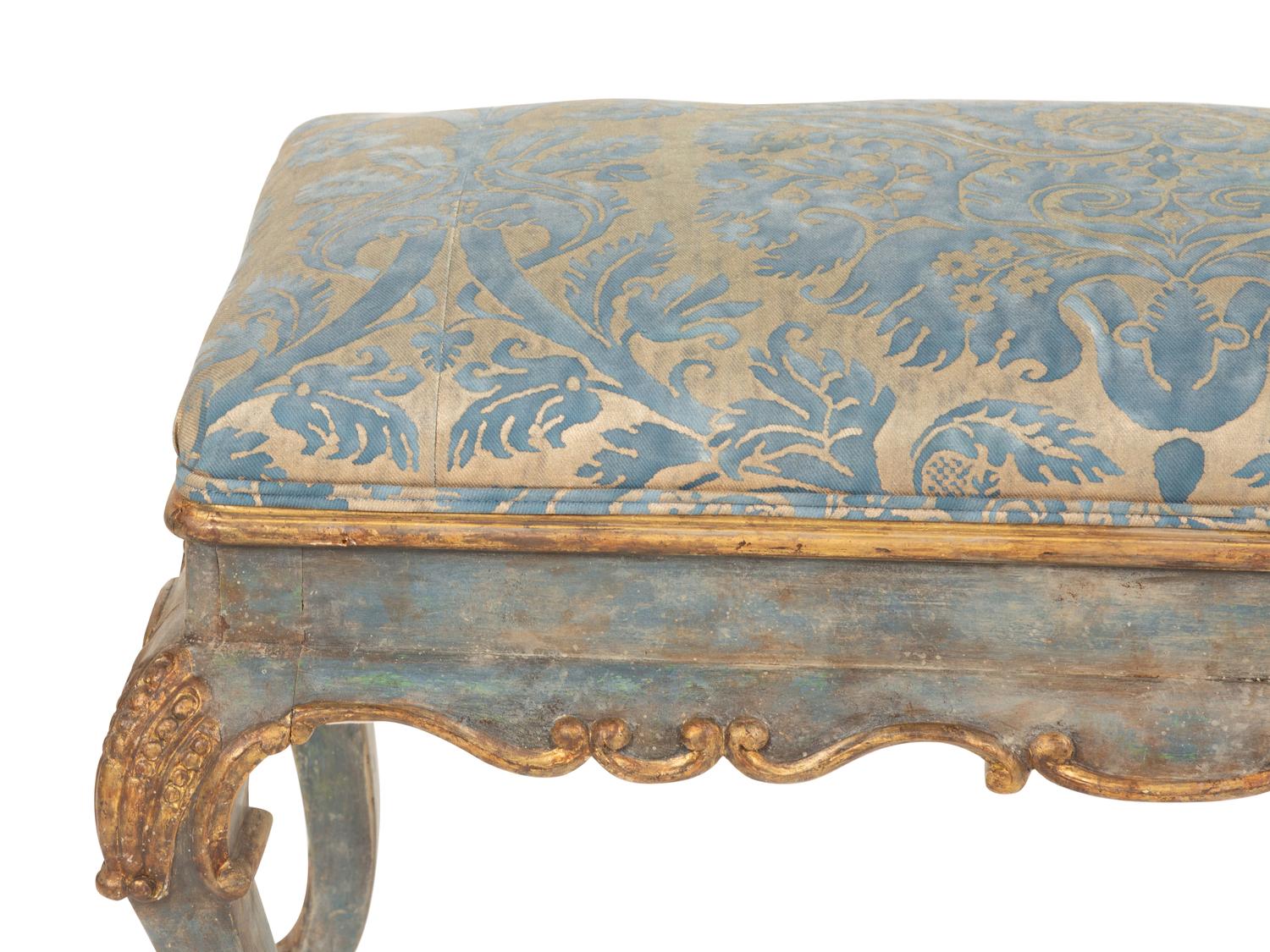 An Italian Painted and Parcel Gilt Bench with Fortuny Upholstery