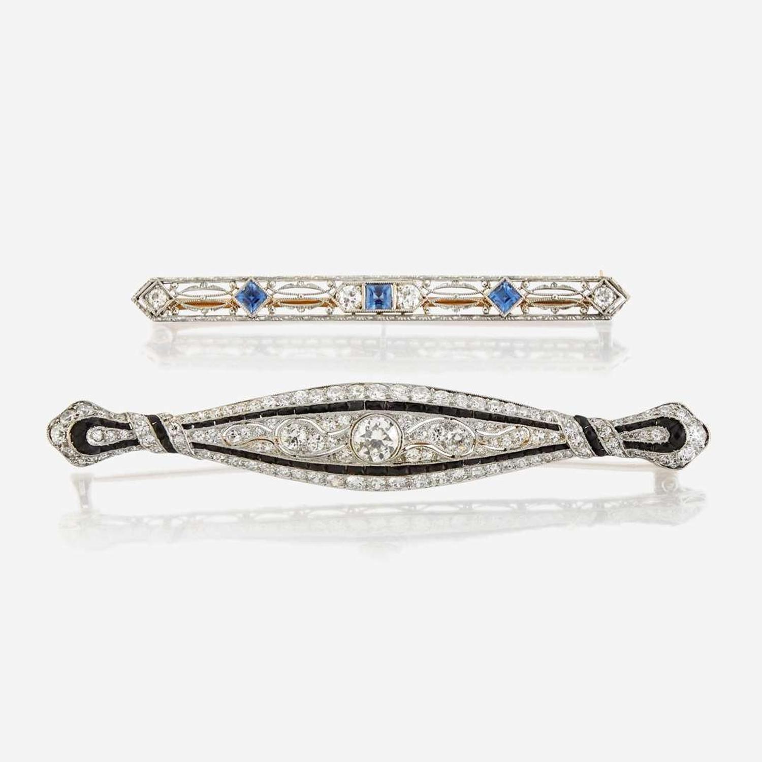 A collection of two diamond, gem-set, and platinum brooches circa 1930s
