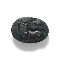 A Roman Bloodstone Ring Stone with a Horse and Palm Tree