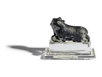 A Mesopotamian Mottled Black Stone Recumbent Bull Amulet