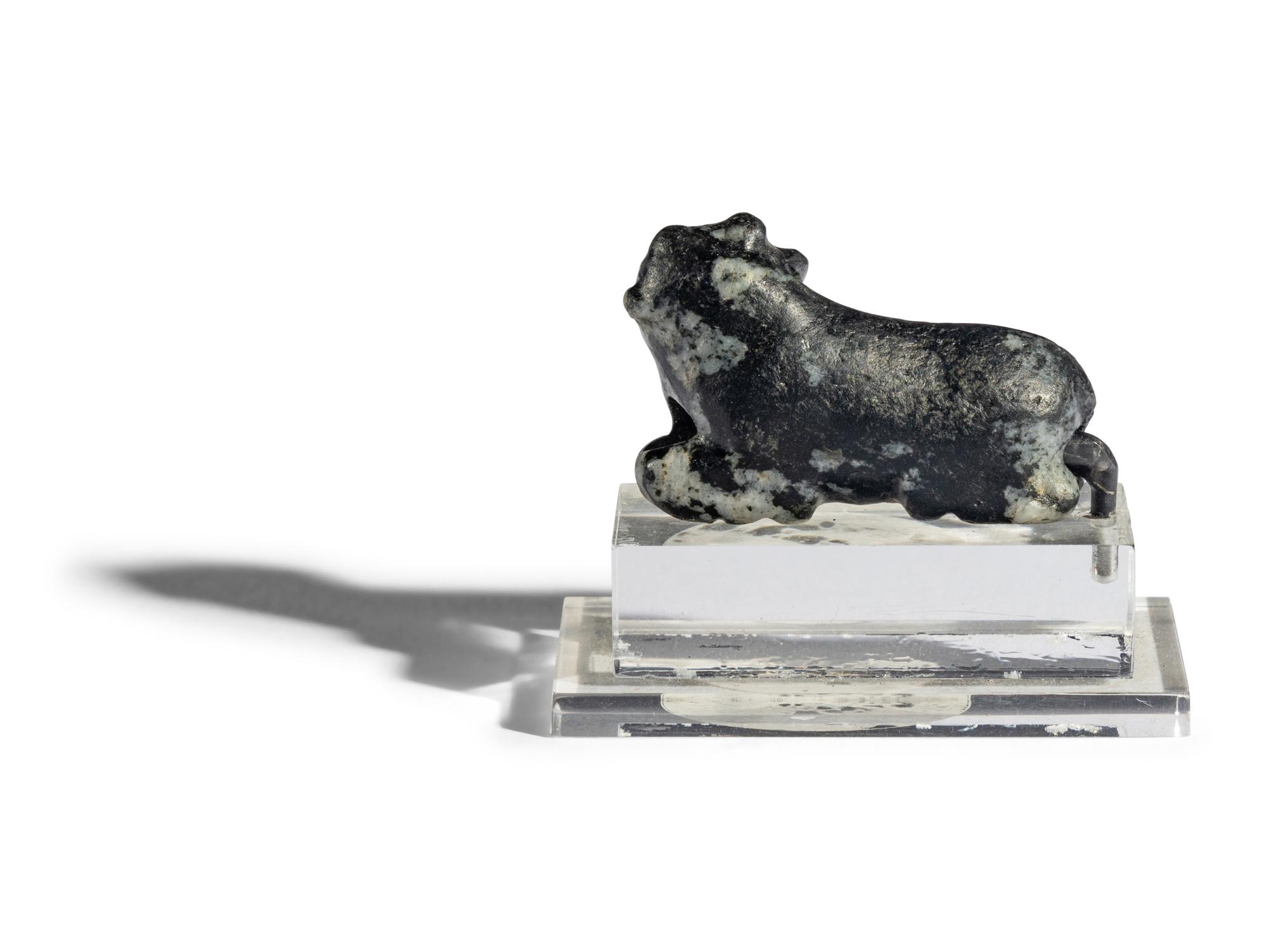 A Mesopotamian Mottled Black Stone Recumbent Bull Amulet