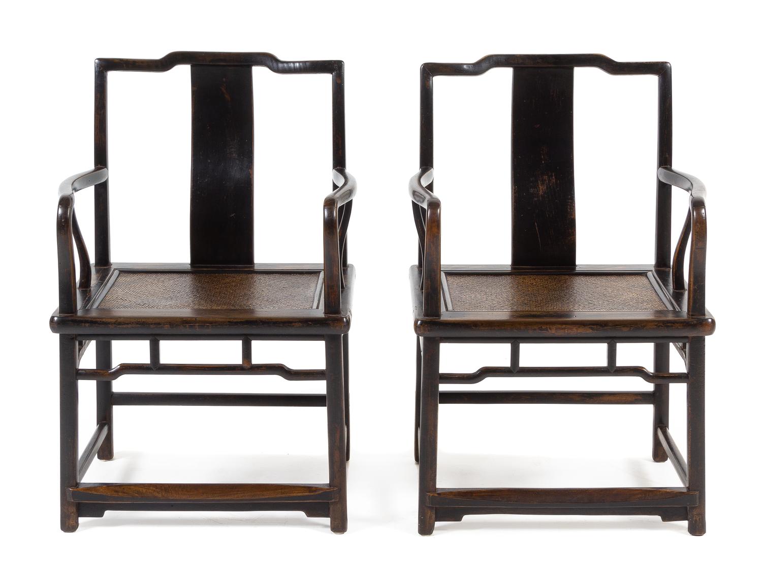 A Pair of Chinese Black Lacquered Elmwood Official's Hat Armchairs, Nanguanmaoyi Height 34 x width 23 1/8 x depth 18 inches. — QING DYNASTY (1644-1911)