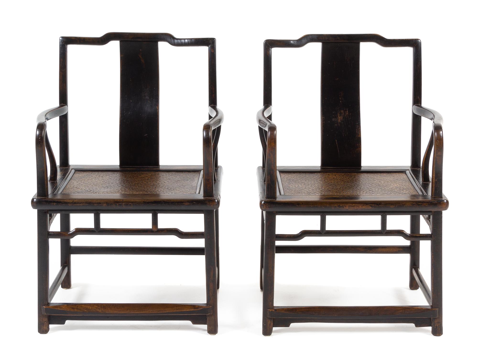 A Pair of Chinese Black Lacquered Elmwood Official's Hat Armchairs, Nanguanmaoyi Height 34 x width 23 1/8 x depth 18 inches. — QING DYNASTY (1644-1911)