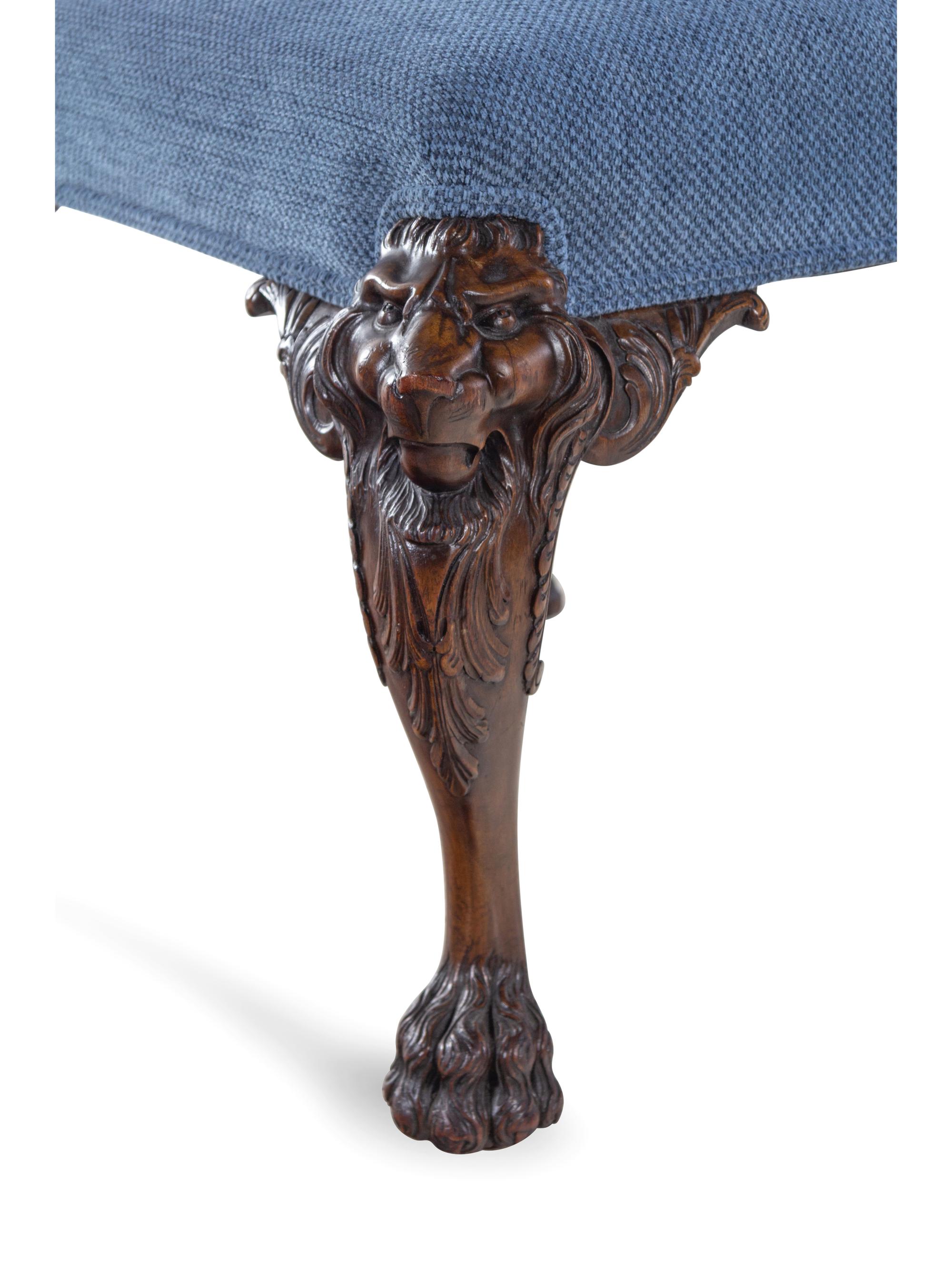 An Edwardian Carved Mahogany Foot Stool