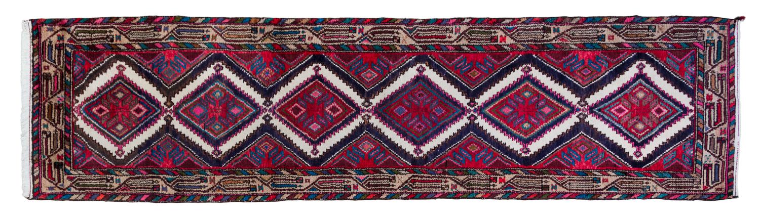 A Persian Wool Runner 9 feet 11 1/2 inches x 2 feet 7 1/2 inches.