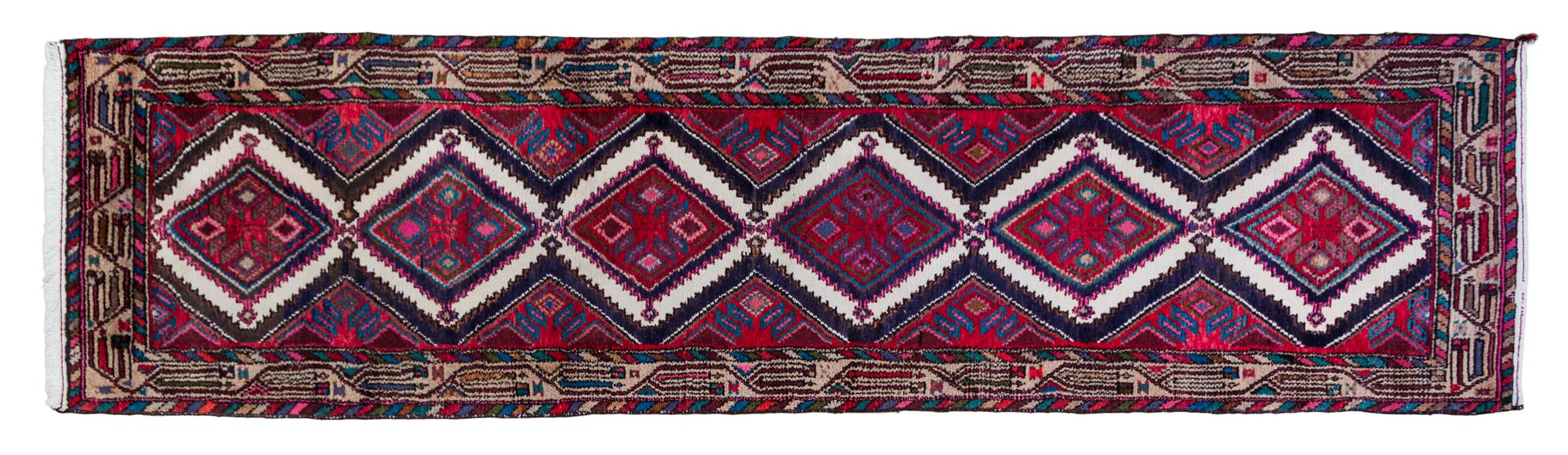 A Persian Wool Runner 9 feet 11 1/2 inches x 2 feet 7 1/2 inches.