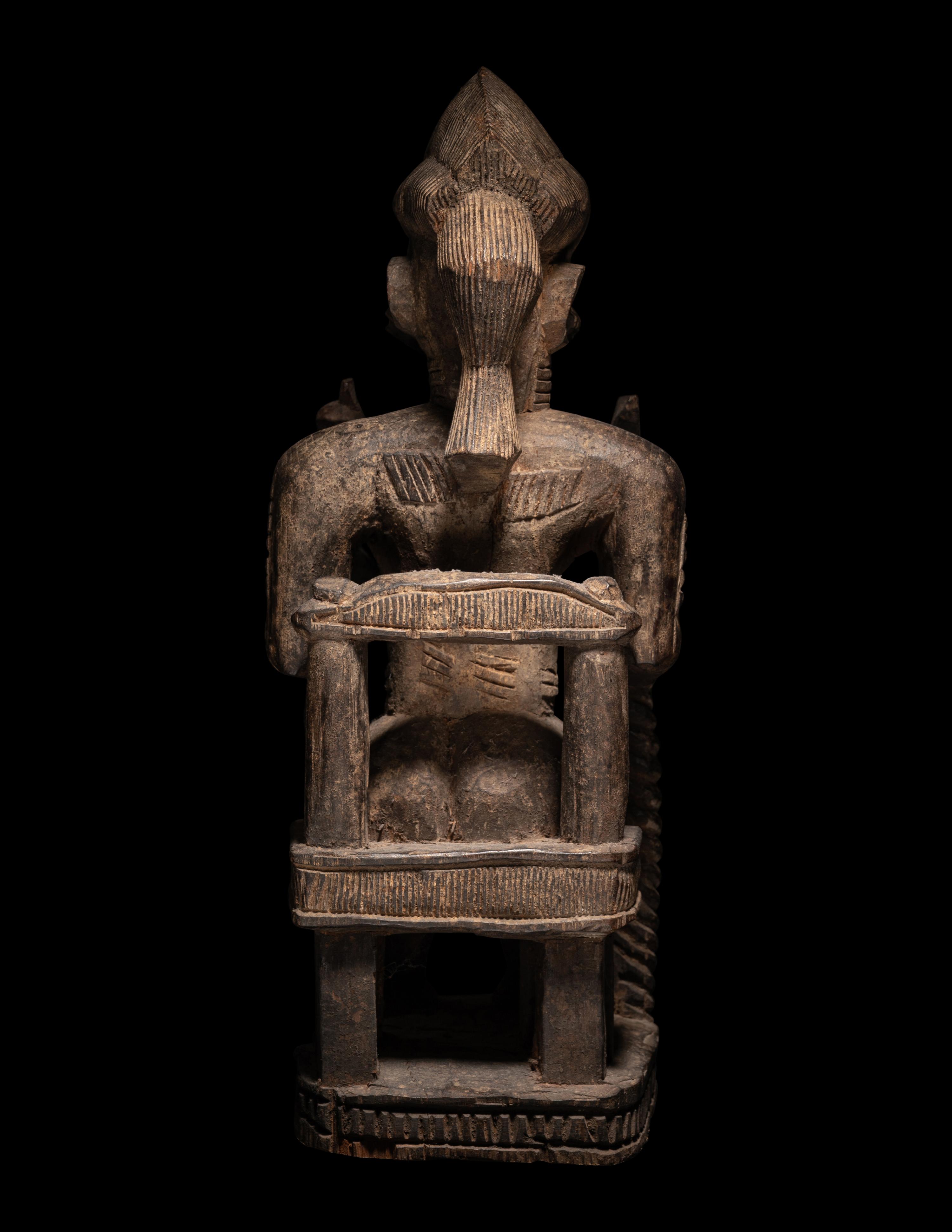 A Baule Wood Seated Male Figure