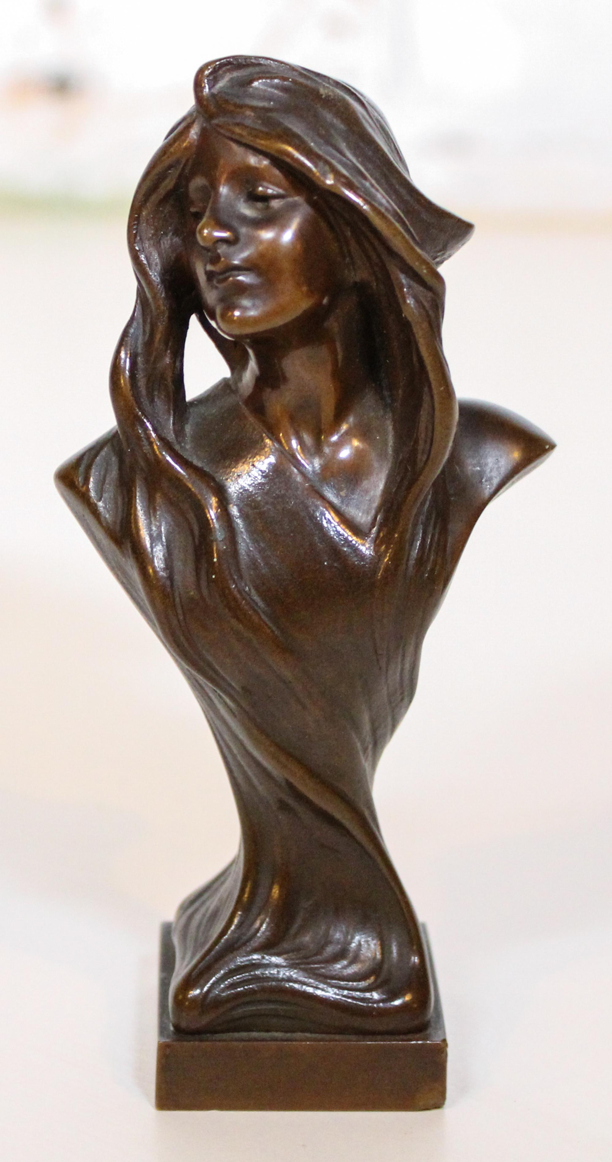 An Art Nouveau Bronze Bust. Height 5 1/4 inches.
