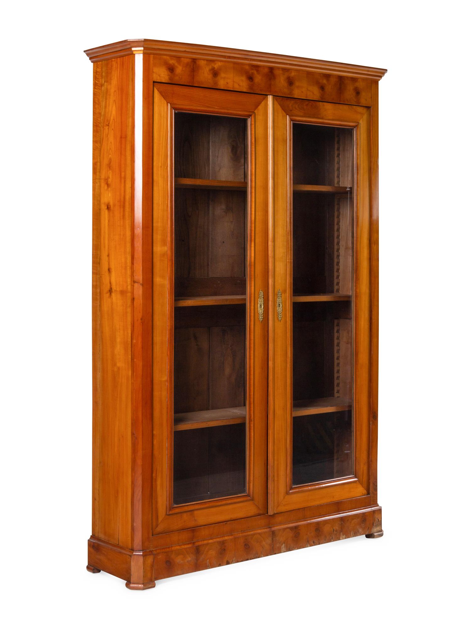 A Biedermeier Figured Walnut Two-Door Bookcase
