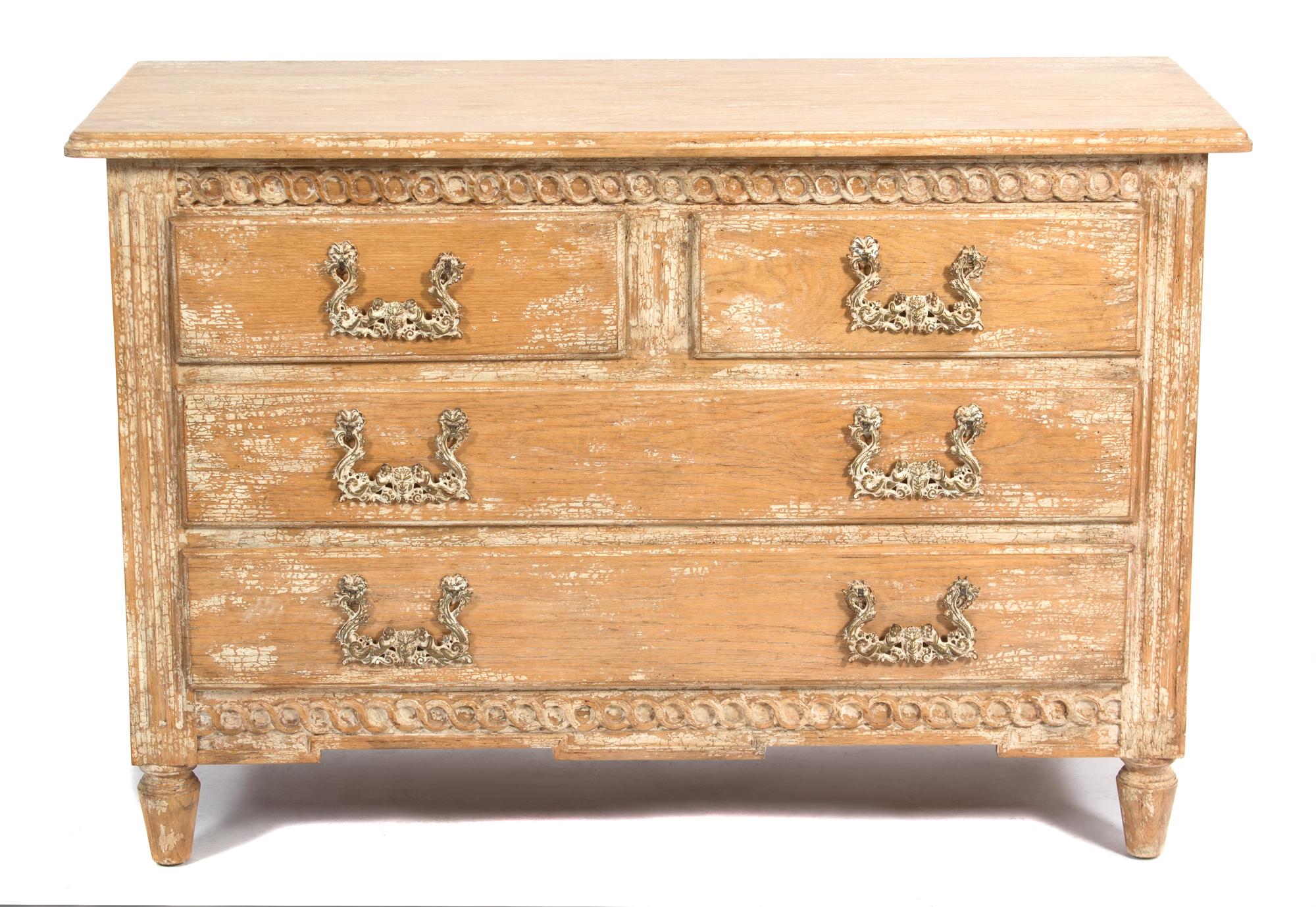 A Provincial Style Carved and Distressed Finish Chest of Drawers height 34 x width 50 1/2 x depth 21 inches. — 20TH CENTURY