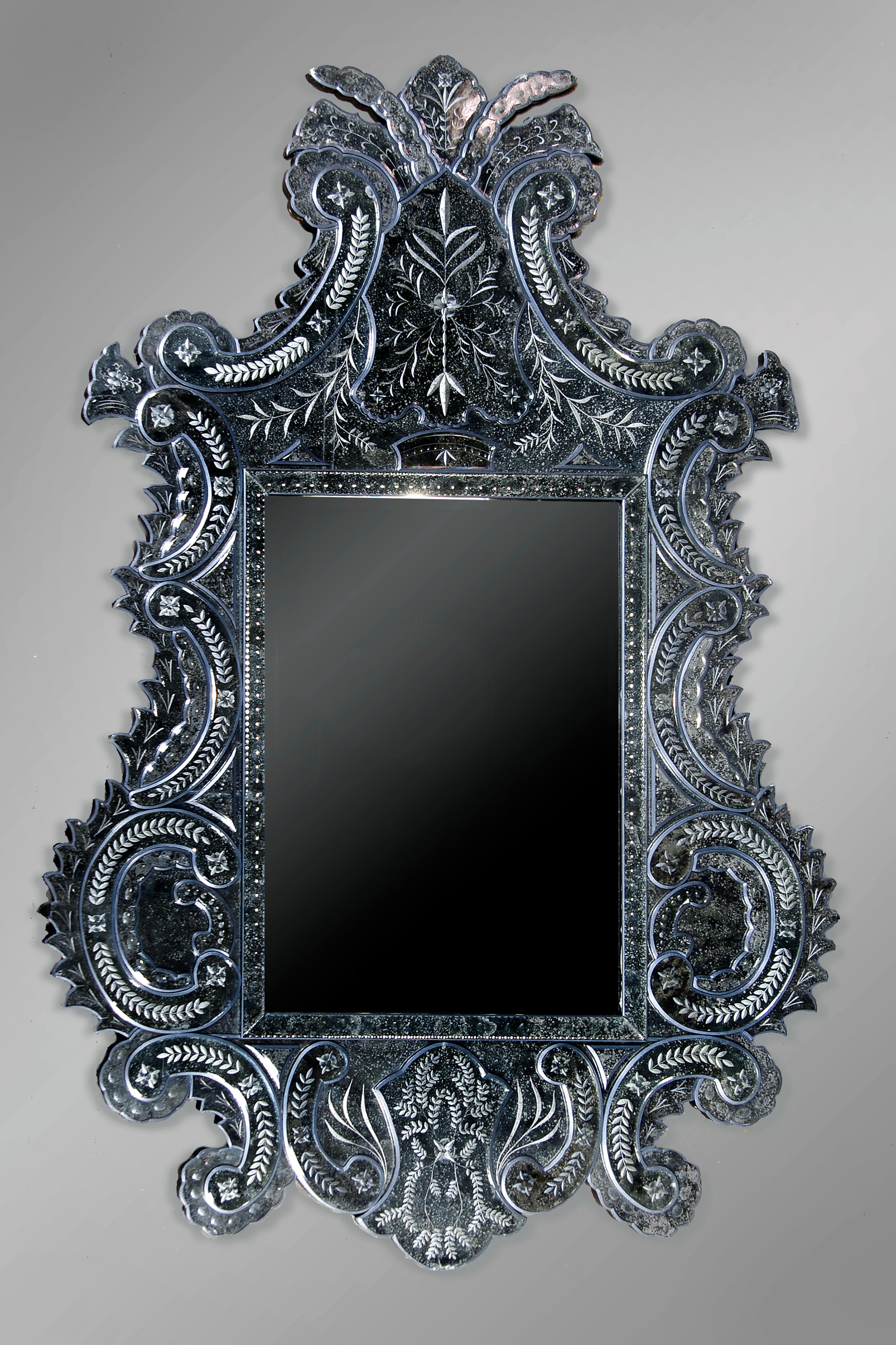 A Venetian Glass Mirror, Height 74 x width 49 1/2 inches.
