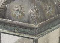 A group of four patinated copper wall-mounted lanterns, modern