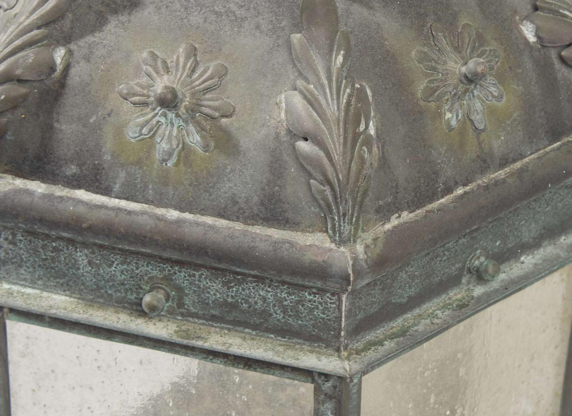 A group of four patinated copper wall-mounted lanterns, modern