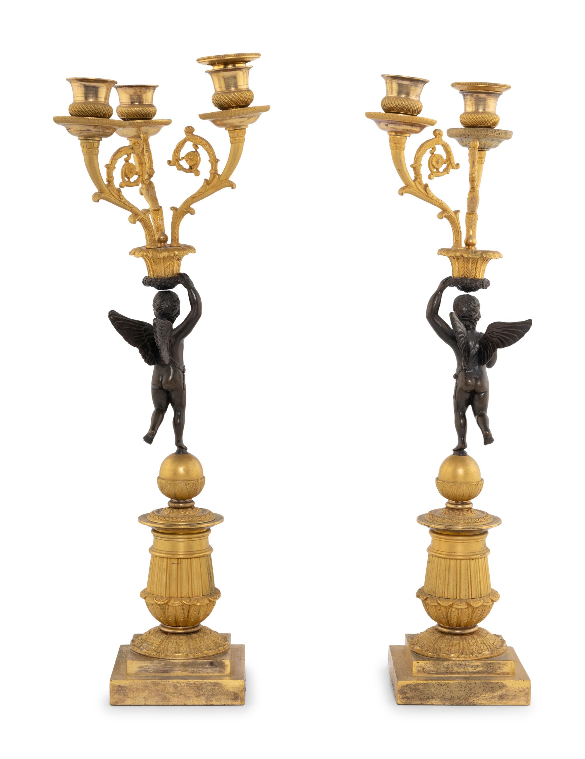 A Pair of Empire Style Gilt and Patinated Bronze Figural Candelabra