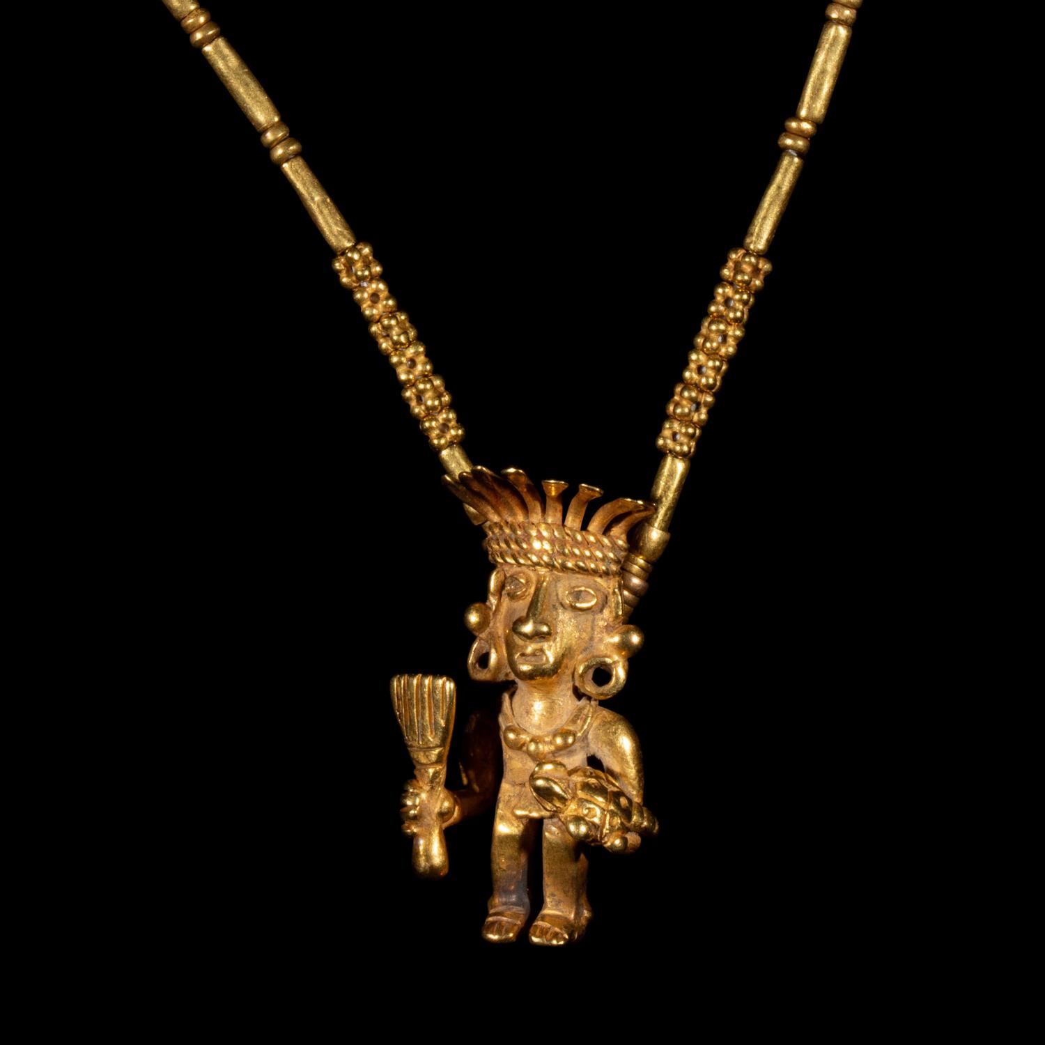 A Costa Rican Tumbaga Figural Pendant — with a gold chain