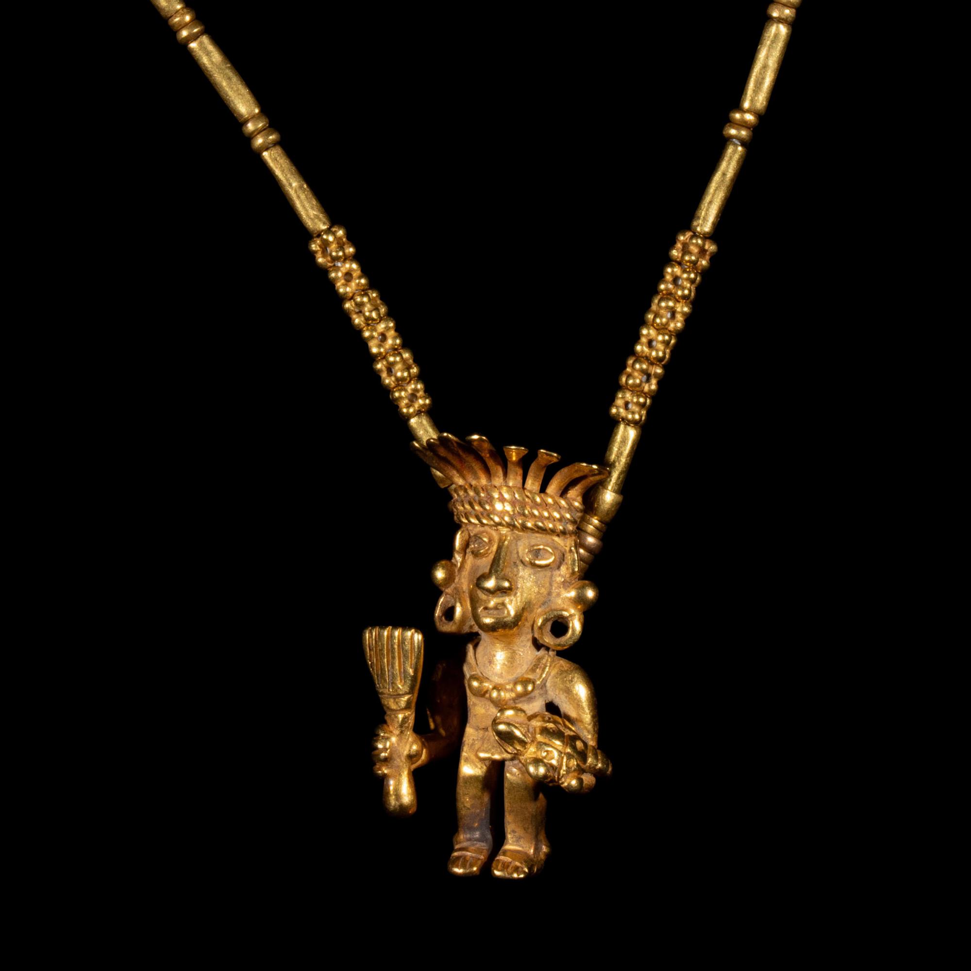 A Costa Rican Tumbaga Figural Pendant — with a gold chain