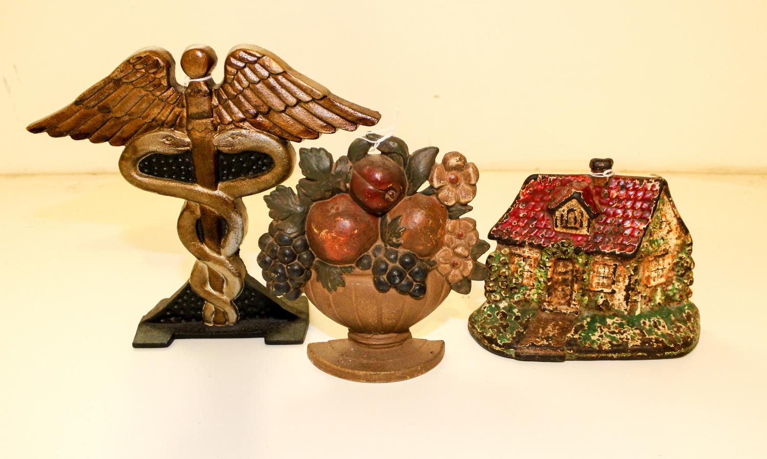 A Group of Cast Iron Doorstops Height of tallest 8 3/4 inches.