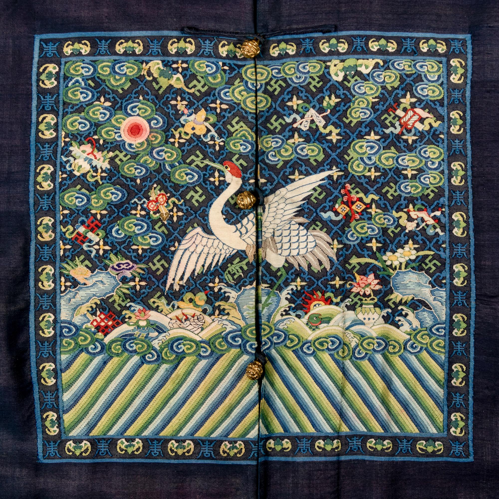 A Chinese Navy Blue Ground Official's Surcoat, Bufu, and A Velvet-Brimmed Winter Hat, Jiguan, 19th Century 清中晚期 藍地一品文官補服及冬吉冠一頂