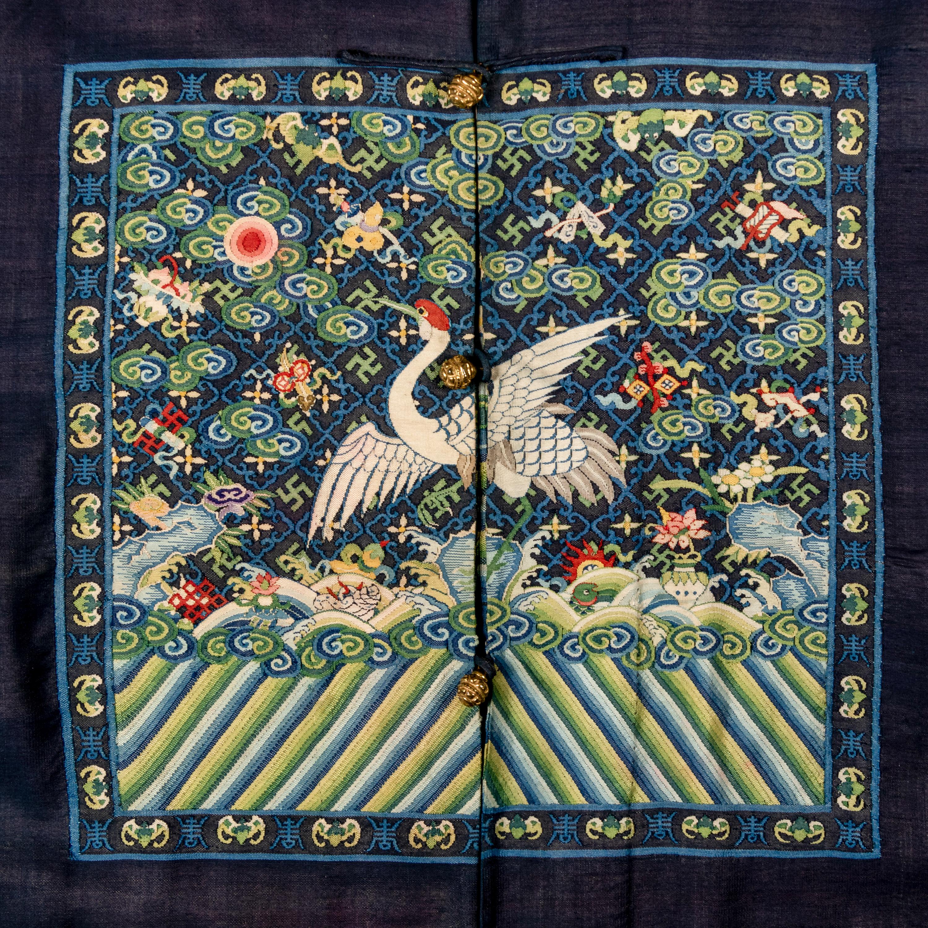 A Chinese Navy Blue Ground Official's Surcoat, Bufu, and A Velvet-Brimmed Winter Hat, Jiguan, 19th Century 清中晚期 藍地一品文官補服及冬吉冠一頂