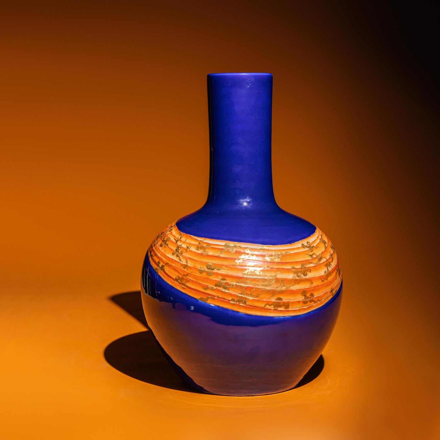 A Large Chinese Gilt and Iron Red Highlighted Blue Glazed Porcelain 'Ribbon-Tied' Vase, Tianqiuping, Late Qing Dynasty/Early Republic Period 晚清/民國 藍地描金包袱式天球瓶