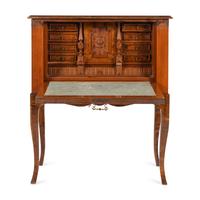 A Continental Carved and Figured Walnut Bureau