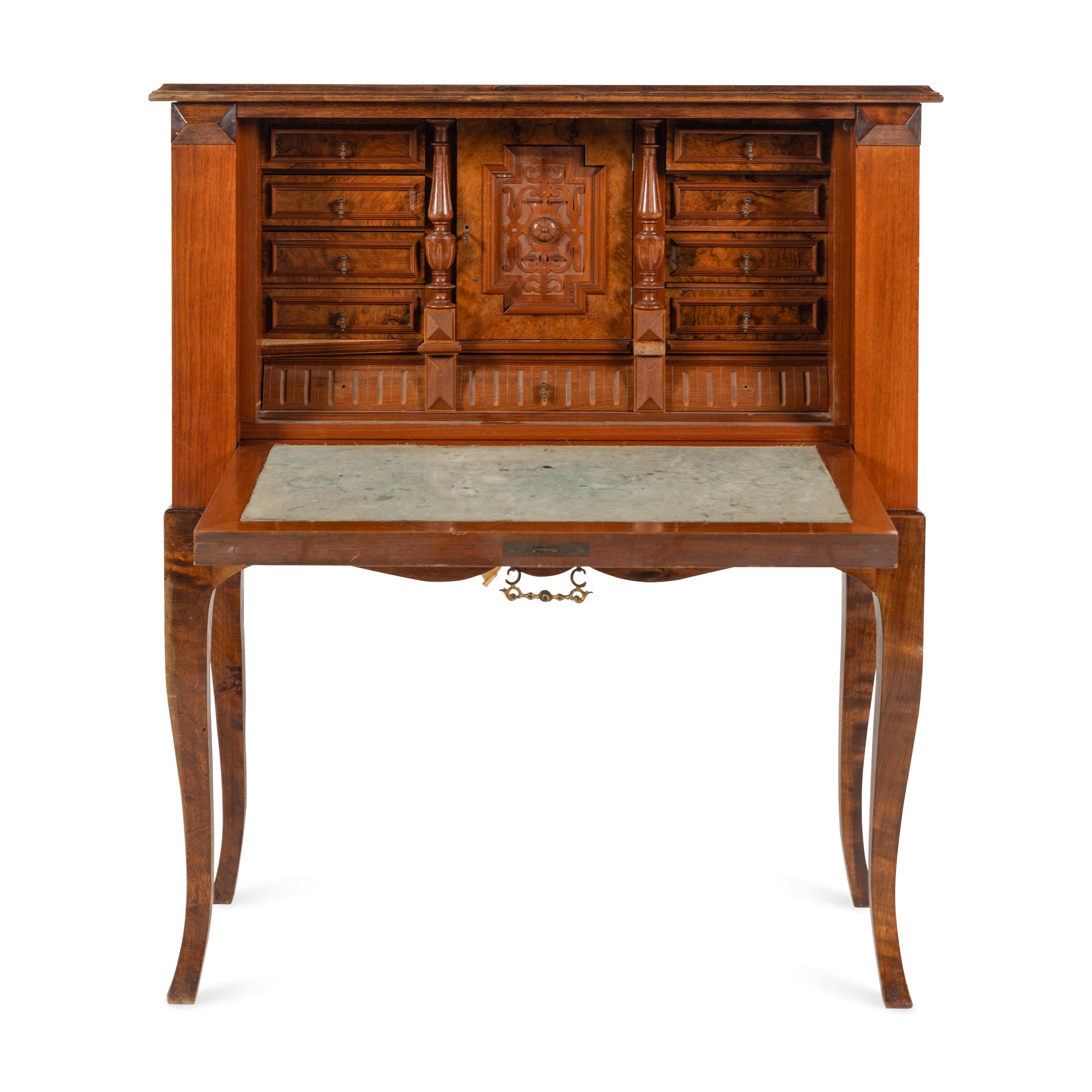 A Continental Carved and Figured Walnut Bureau