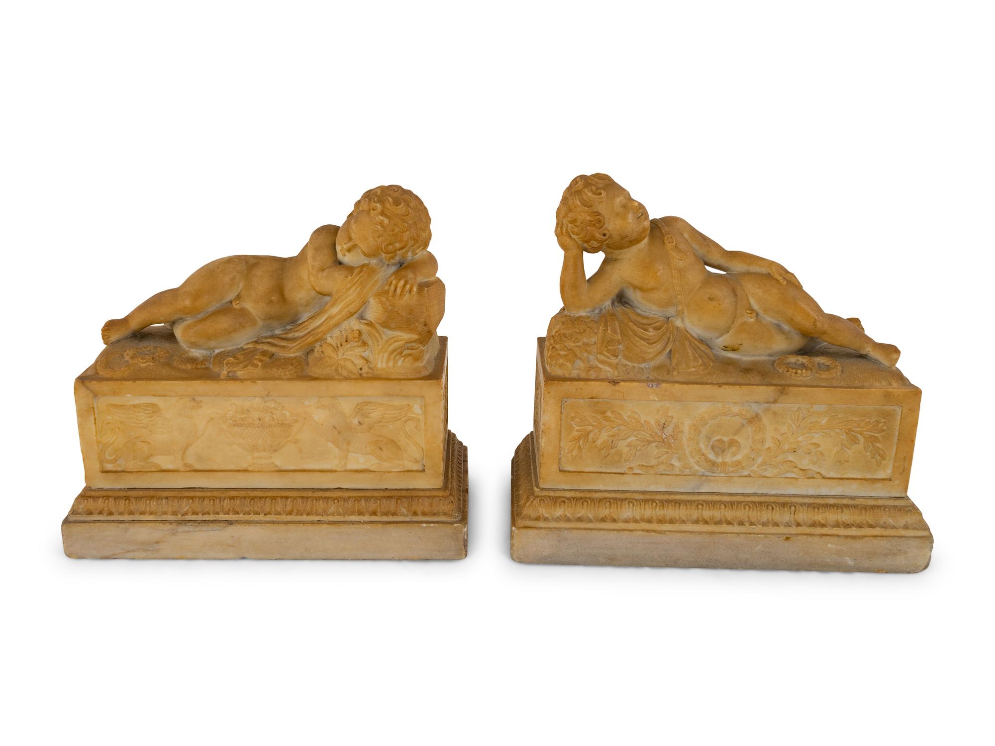 A Pair of Marble Models of Sleeping Cherubs on Plinths