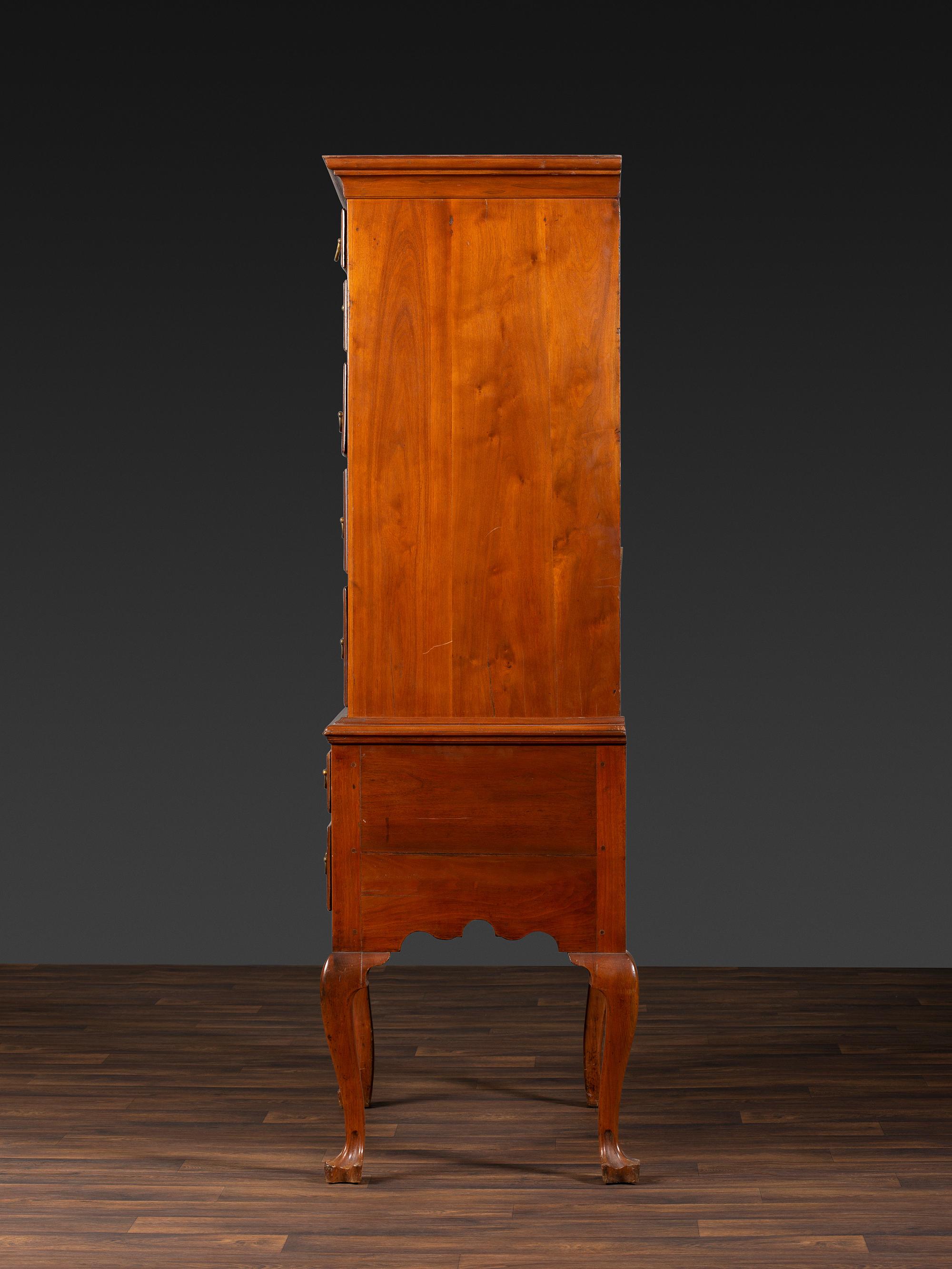 A Queen Anne Figured Walnut Flat-Top Trifid-Foot High Chest