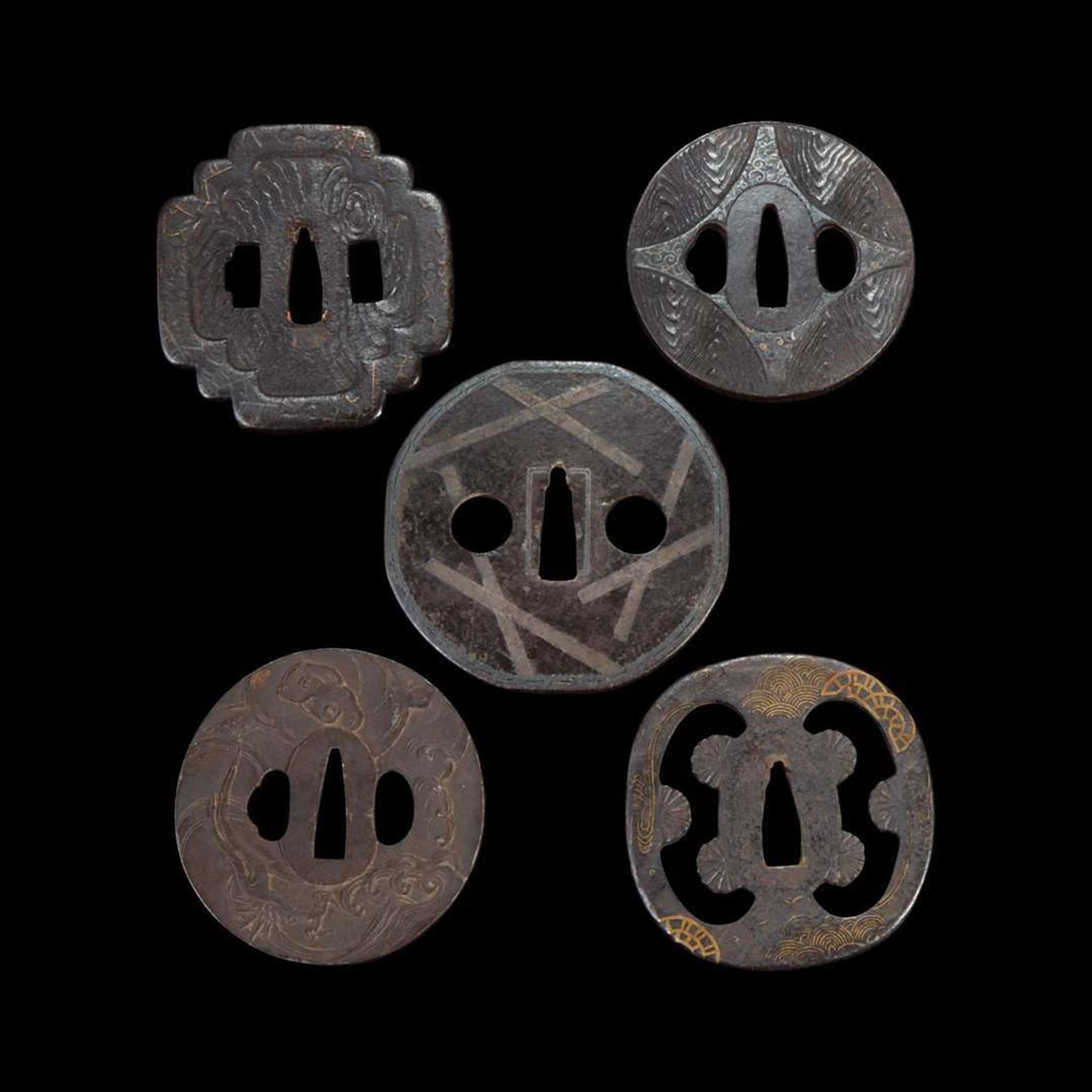 Group of ten Japanese inlaid iron tsuba Edo period or earlier