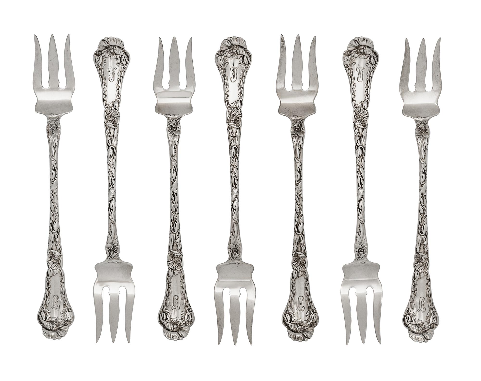 A Set of Twelve American Silver Cocktail Forks, Gorham Mfg. Co., Providence, RI, each with a foliate decorated handle and shaft.